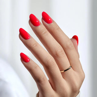 Hand with red nail polish on a white background