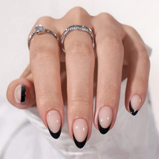 Hand with black and white nail design on a white background