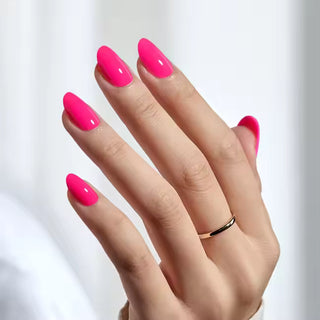 Hand with bright pink nails on a white background