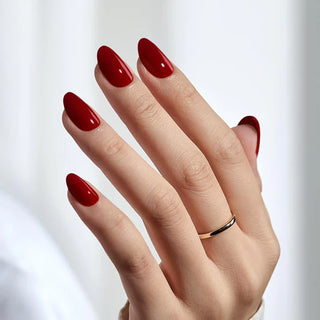 Hand with red nail polish on a white background