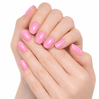 Close-up of hands with pink nail polish on a white background