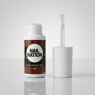 Nail Nation brush on glue with applicator over a white backgroun