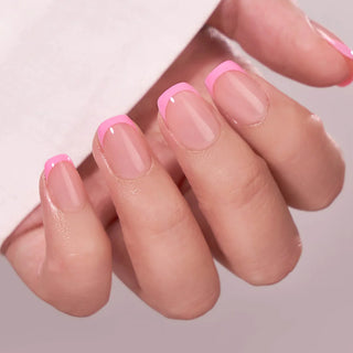 Close-up of a hand with pink nail polish on a light background