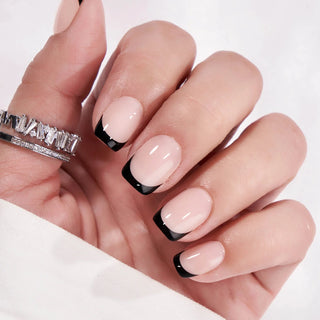 Hand with pink and black nail design on a white background