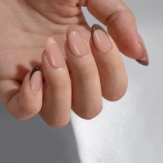 Close-up of a hand with beige nail polish on a neutral background