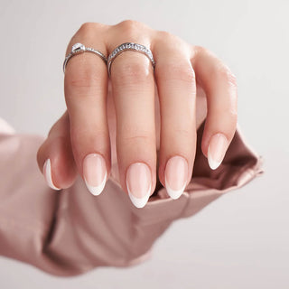 Hand with two rings on a neutral background