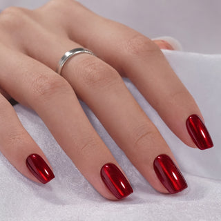 Hand with red press-on nails on a white background