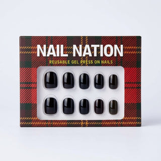 Box of Nail Nation reusable gel press on nails with black nails on a plaid patterned background